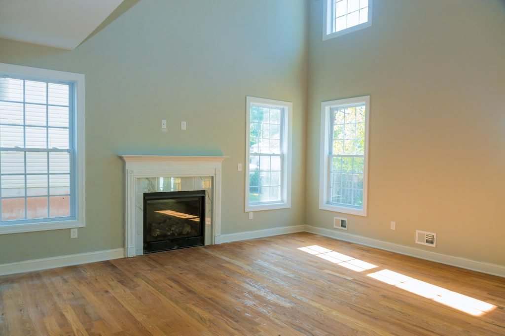 Beautiful interior wide shot of an empty large modern house living room with a fireplace eves cleaning utah