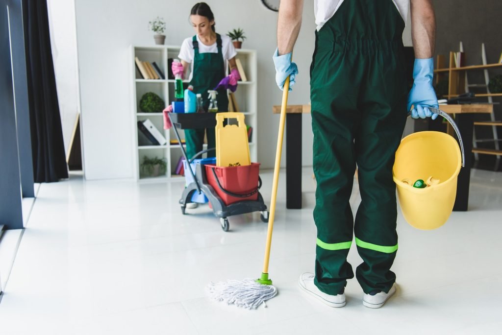 cropped shot of young cleaning company workers holding various cleaning equipment in office-eves cleaning utah