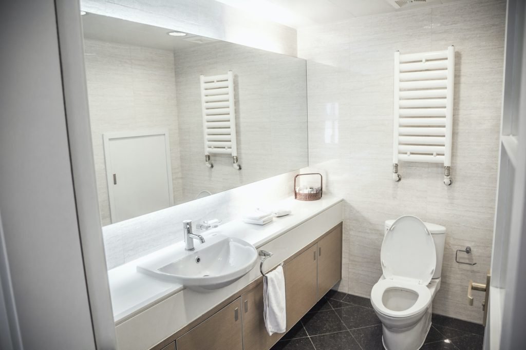 Modern, clean, bathroom with toilet and sink - house cleaning services utah - eves