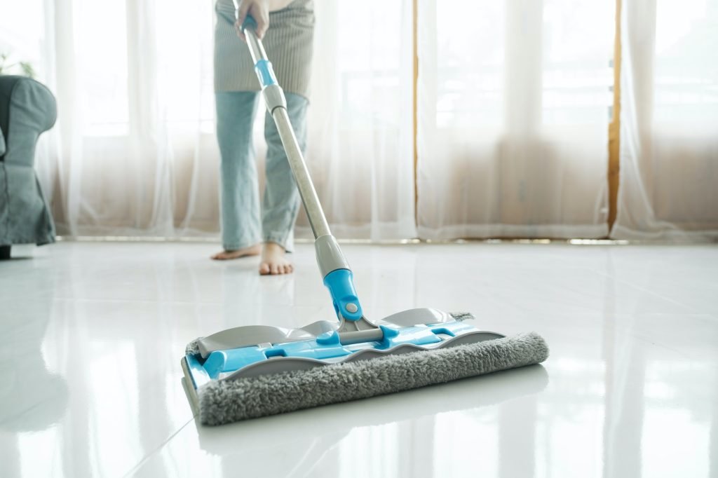 cleaning floor using mop at home - house cleaning services utah - eves